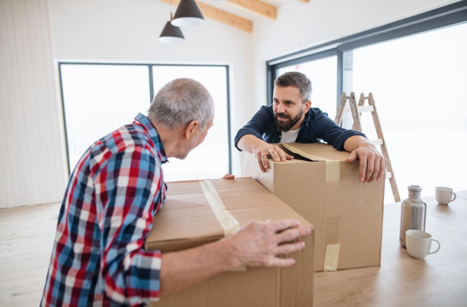 an adult son helping his senior dad to move to assisted living