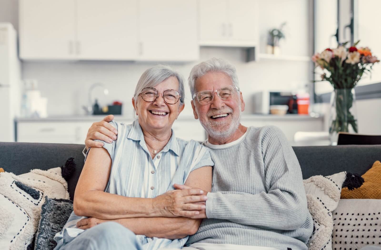 senior couple holding each other and smiling senior living